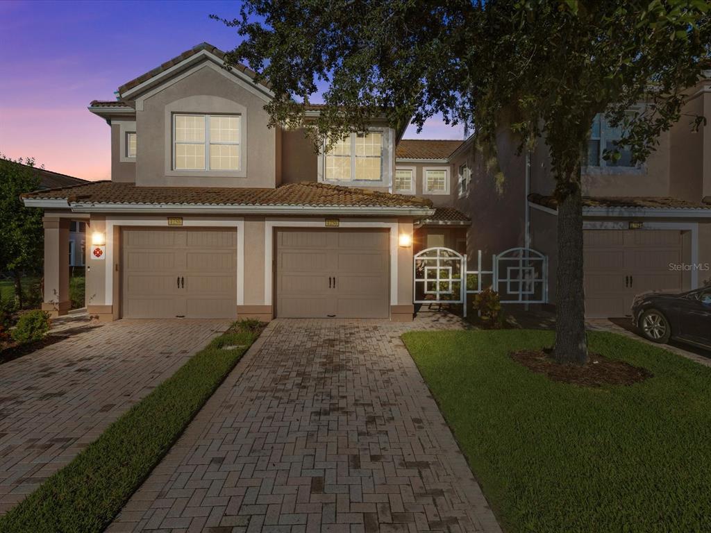 a front view of a house with a yard and garage