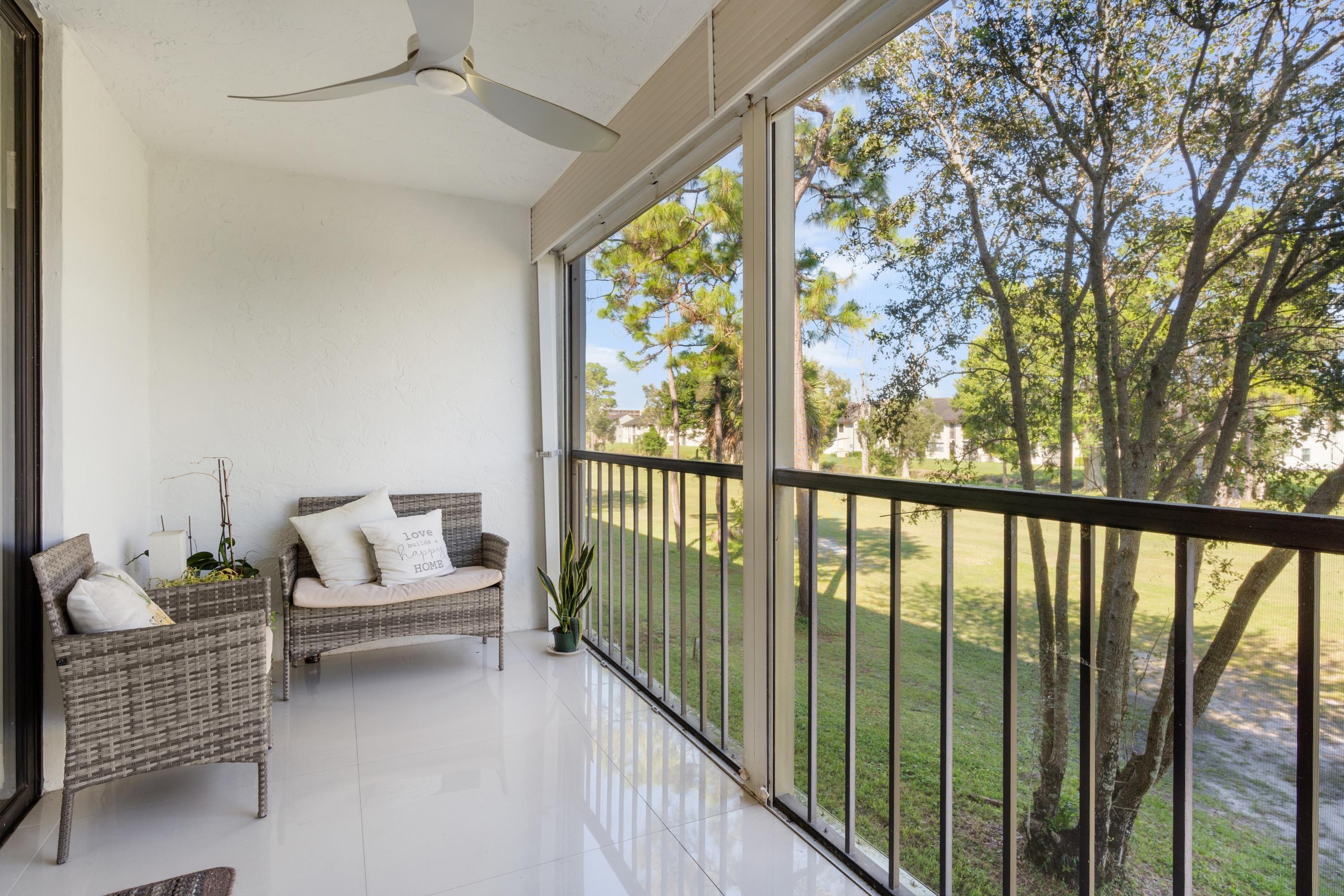 a balcony with furniture and garden view