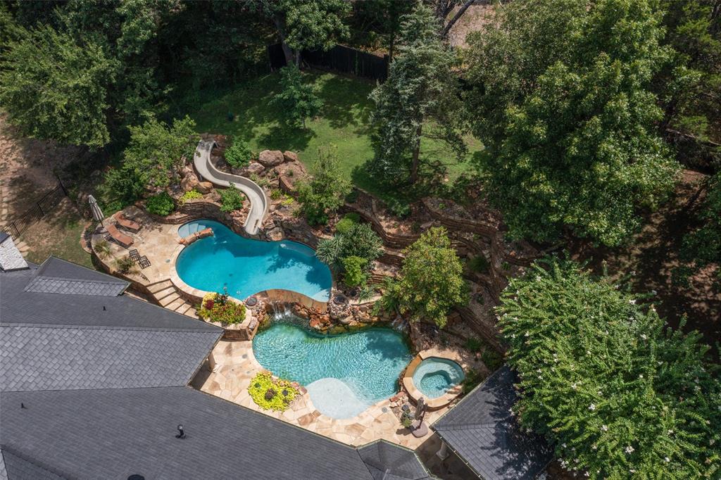 an aerial view of a house with yard swimming pool and outdoor seating