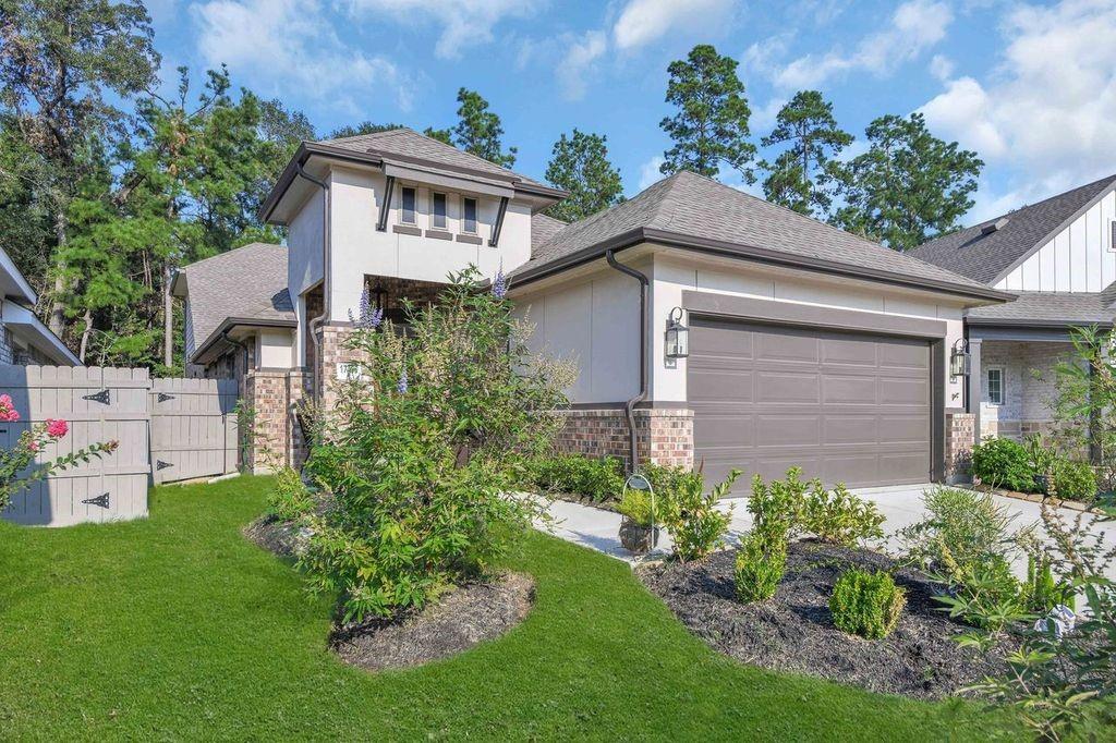 a front view of a house with a garden