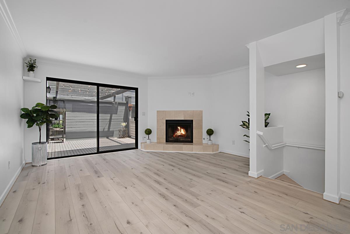 wooden floor fireplace and natural light in room