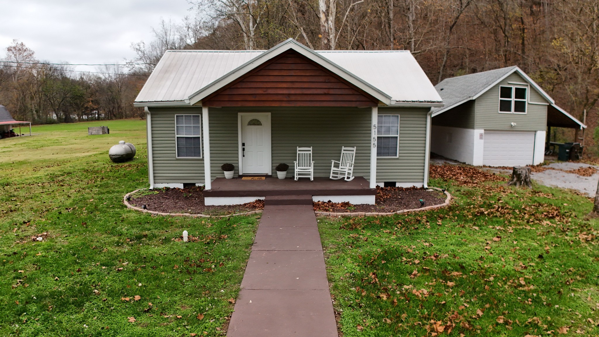 a front view of a house with yard and green space