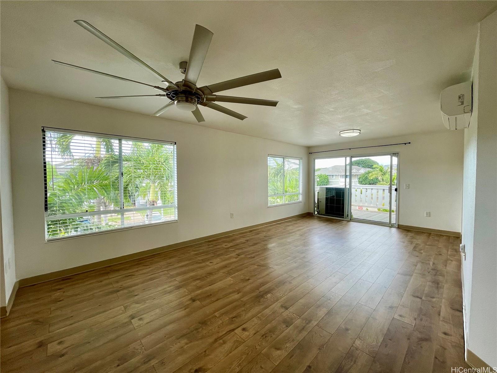 a view of a livingroom with a window and wooden floor