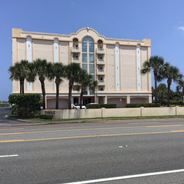 a view of a big building next to a yard