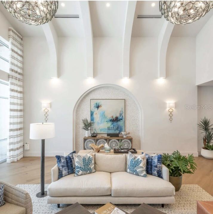 a living room with furniture and a potted plant