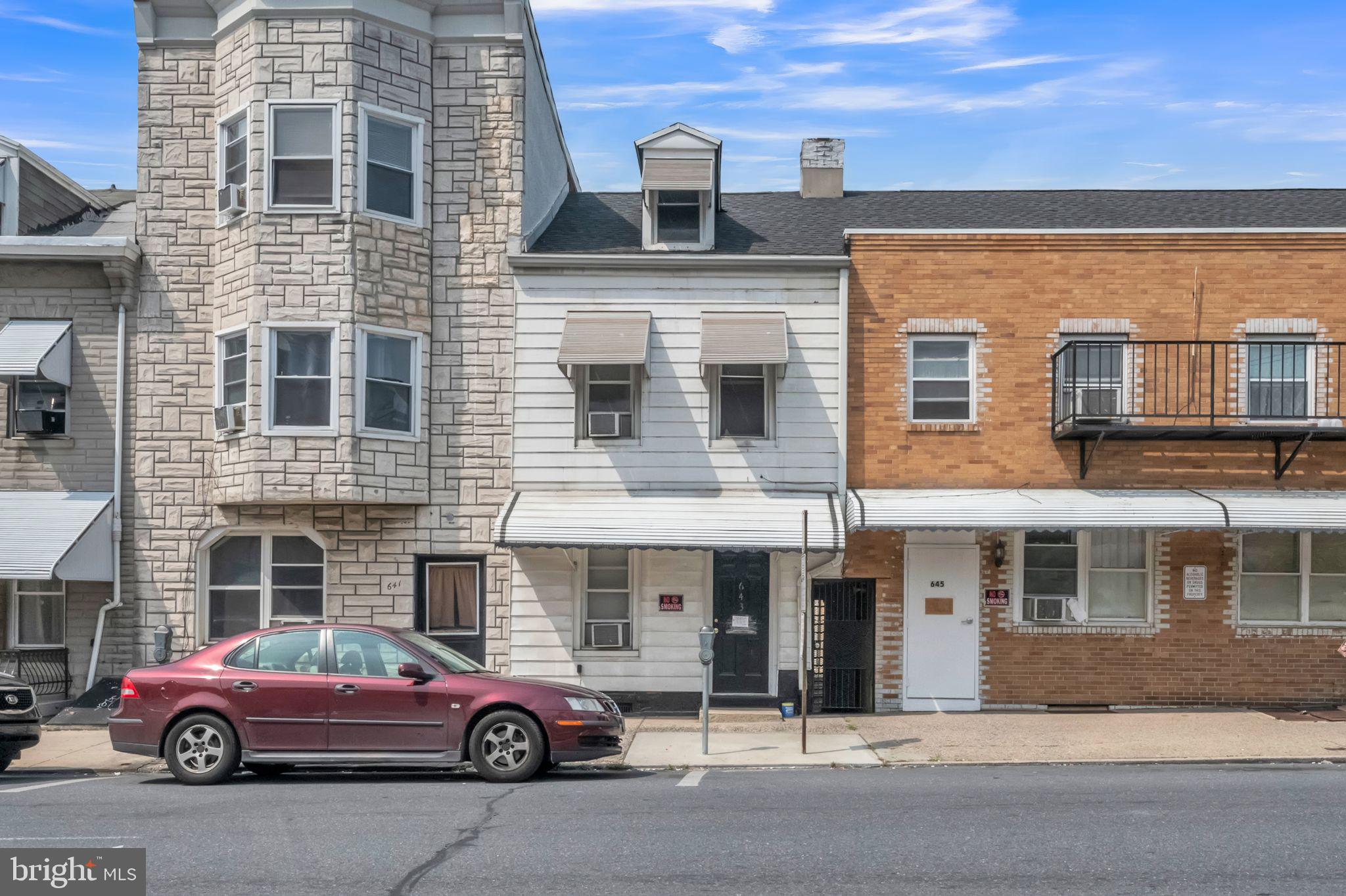 a front view of a building with parking space and parking space