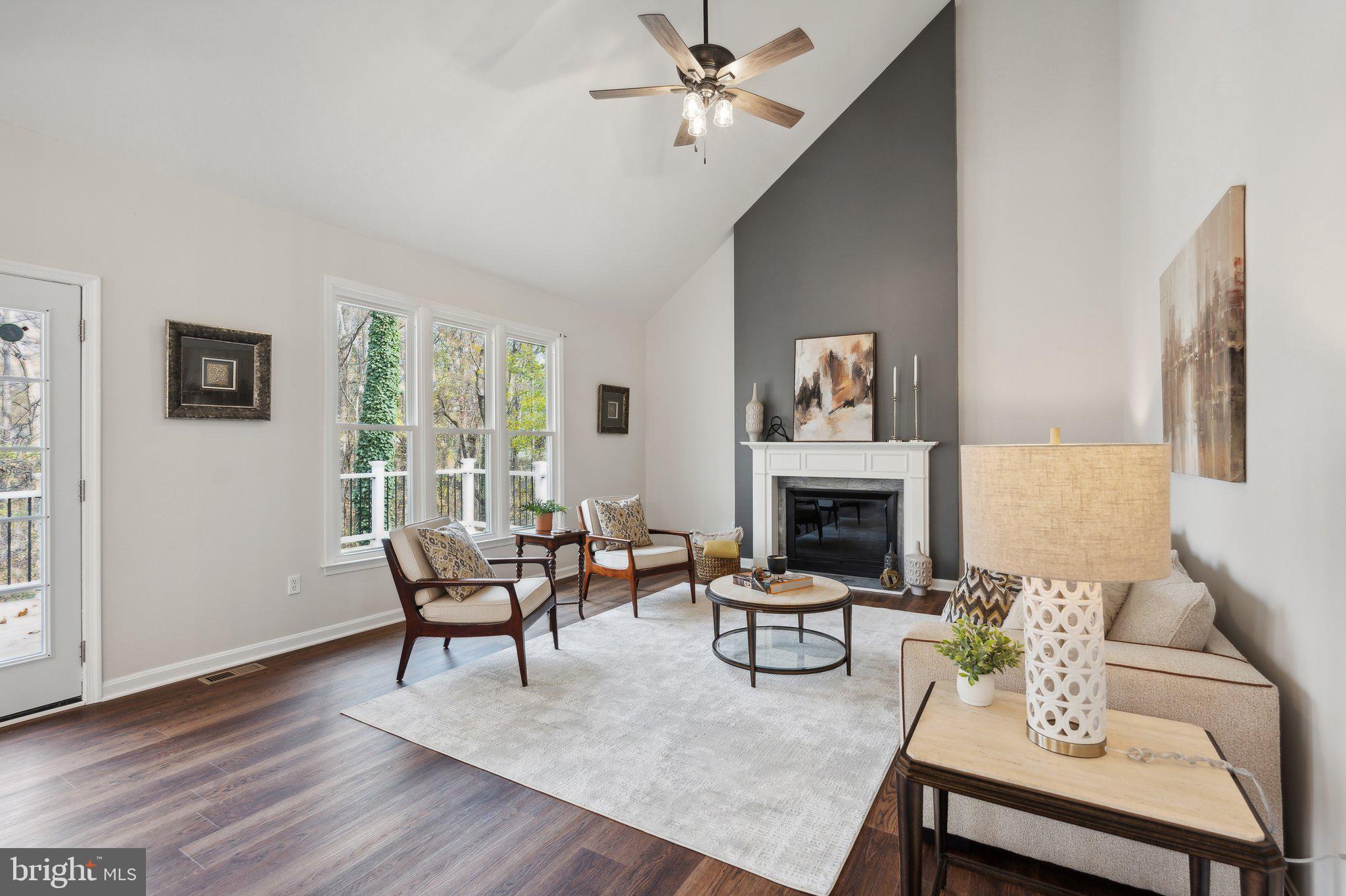 a living room with furniture a fireplace and a window