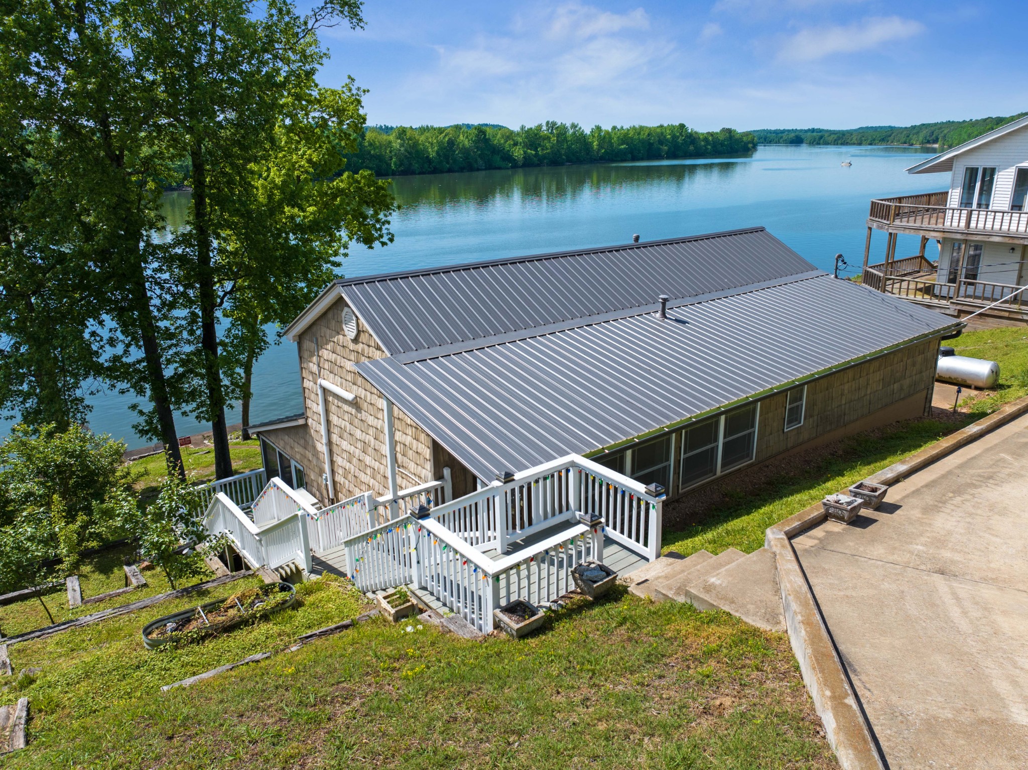 a view of a house with pool and lake view