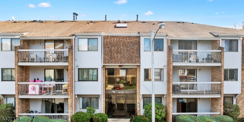 a front view of a residential apartment building with a yard