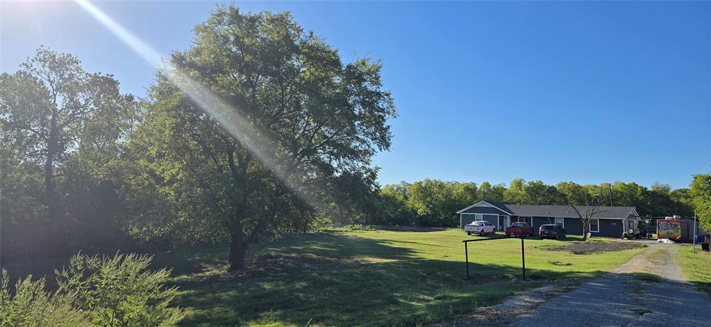 a view of a house with a yard and sitting area