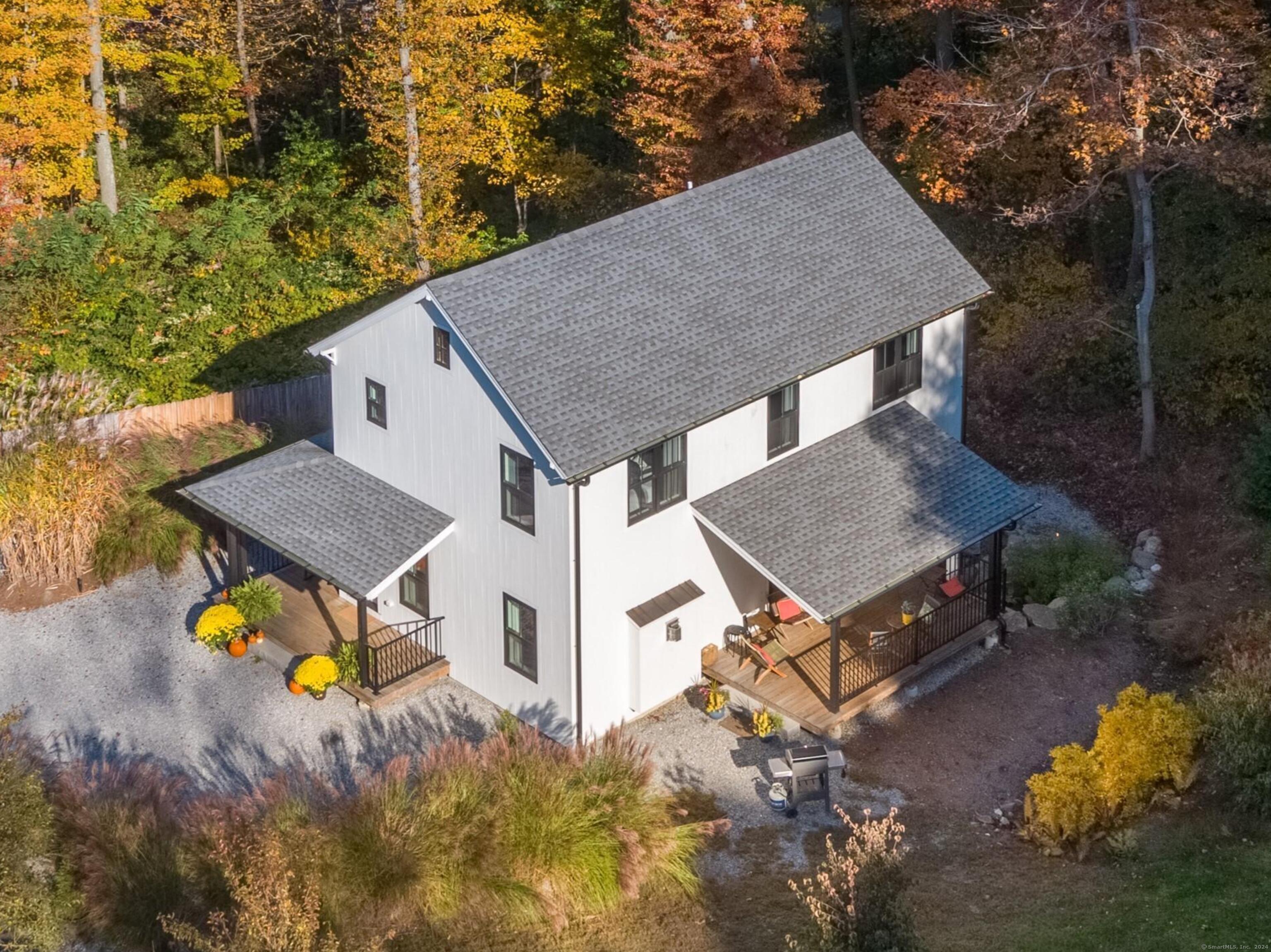 an aerial view of a house with swimming pool and big yard