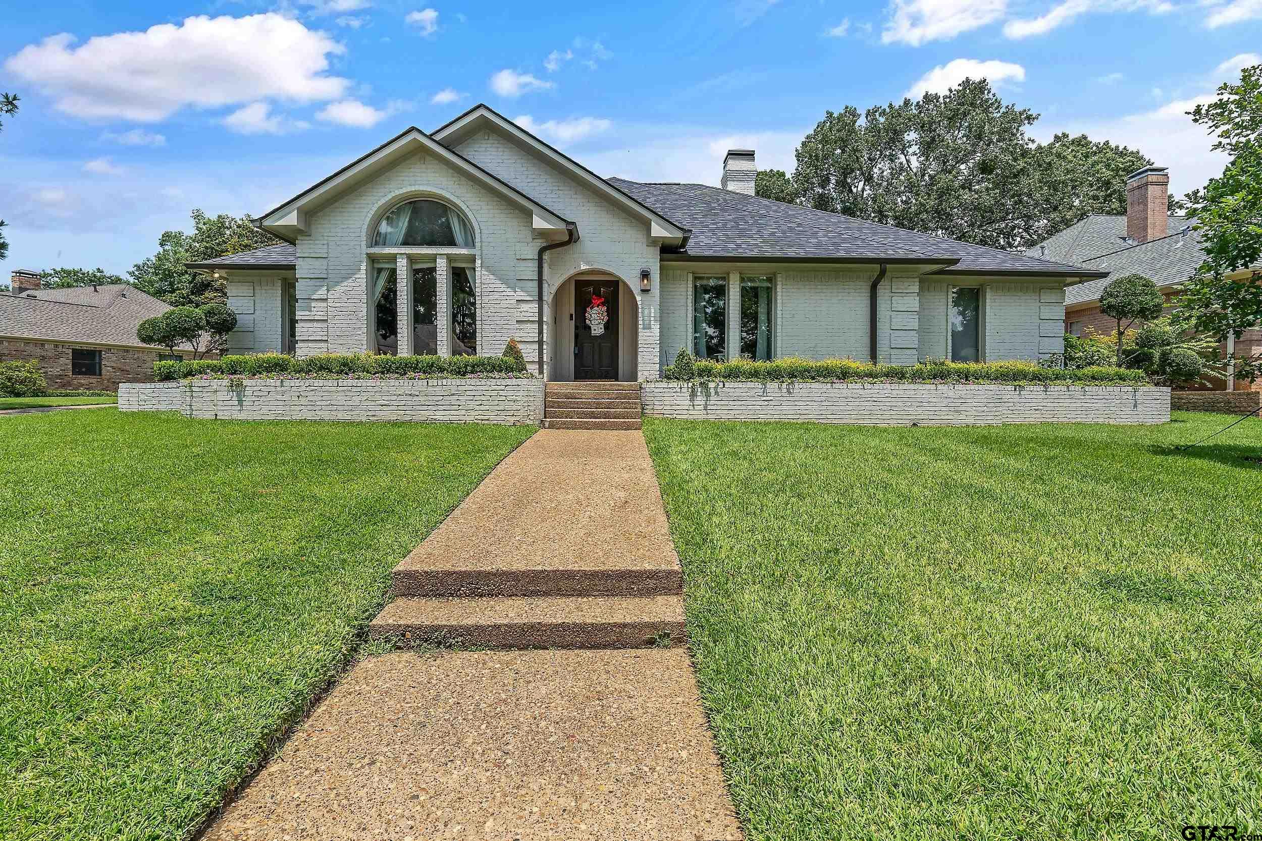 a front view of a house with yard