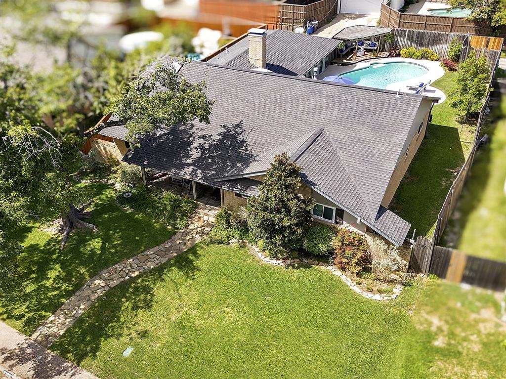 a backyard of a house with a yard and outdoor seating