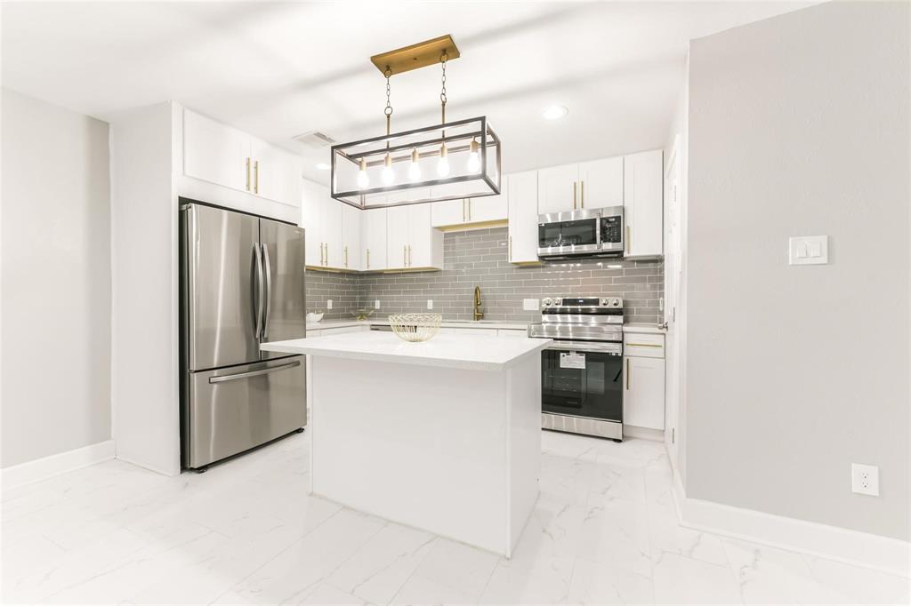 a kitchen with a refrigerator stove and microwave