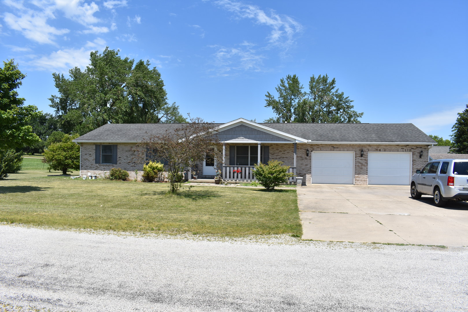 a front view of a house with a garden and porch