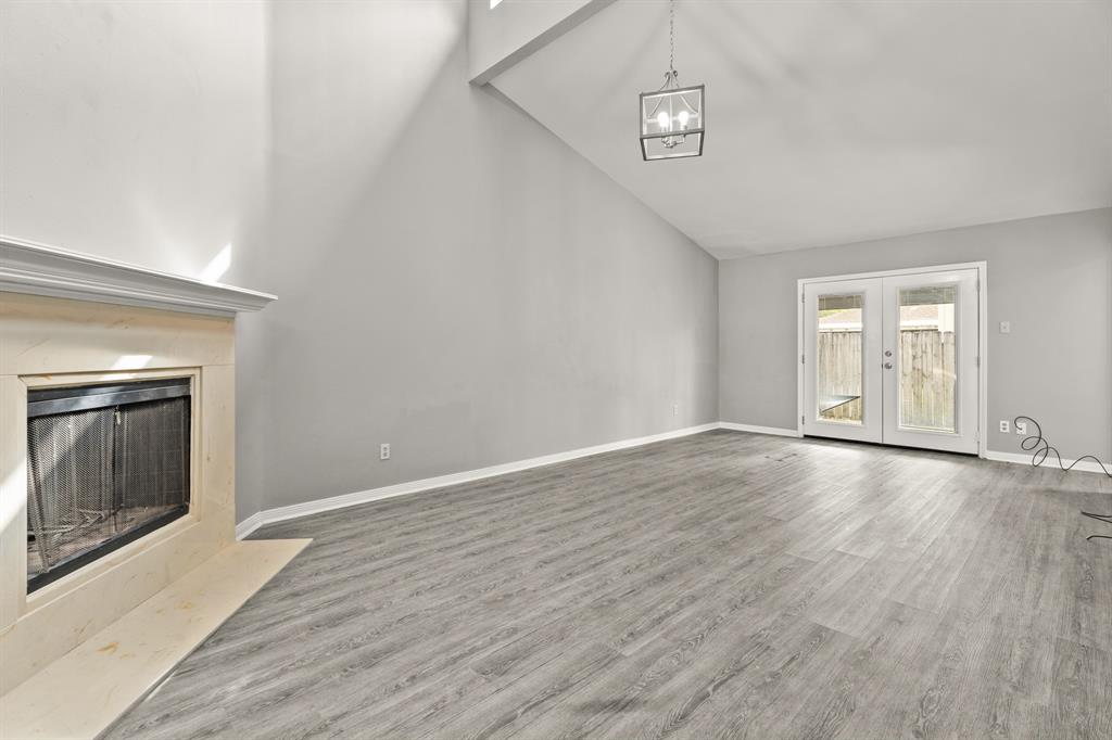 wooden floor in an empty room with a fireplace