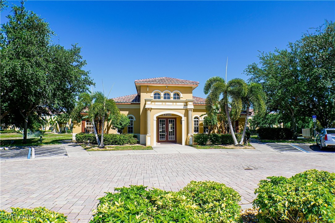 a front view of a house with yard and green space