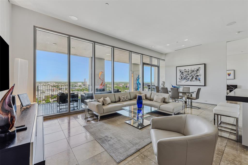 a living room with furniture and floor to ceiling windows