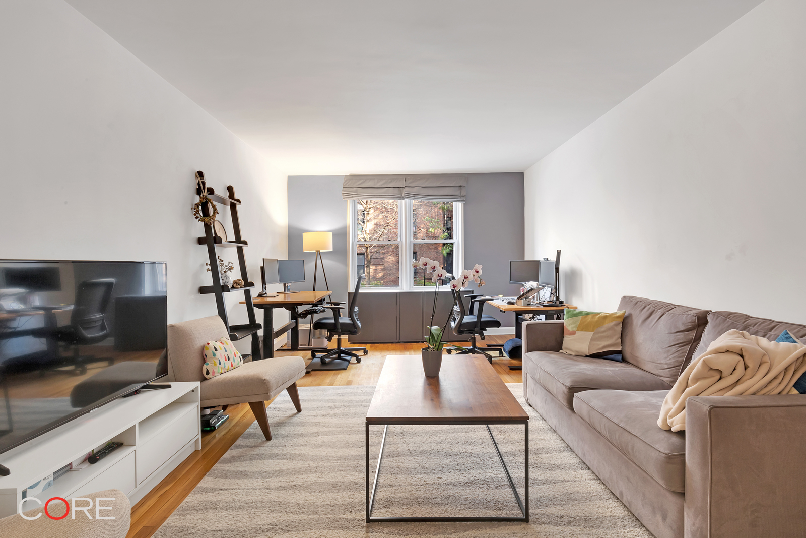 a living room with furniture and a flat screen tv