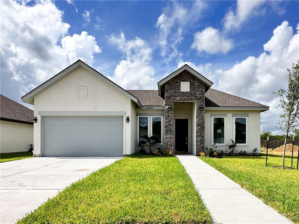 a front view of a house with a yard and porch