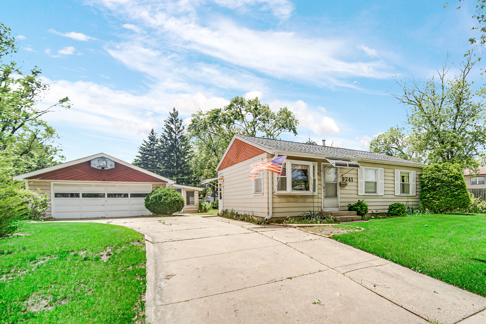 a front view of house with yard and green space