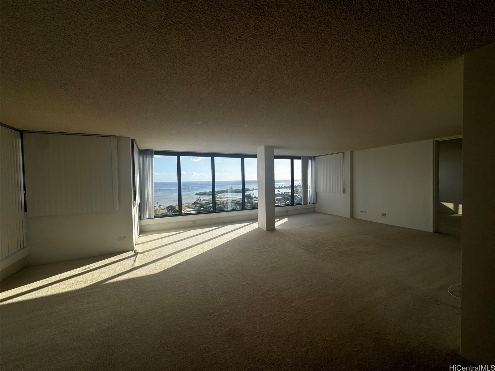 a view of empty room with floor to ceiling window