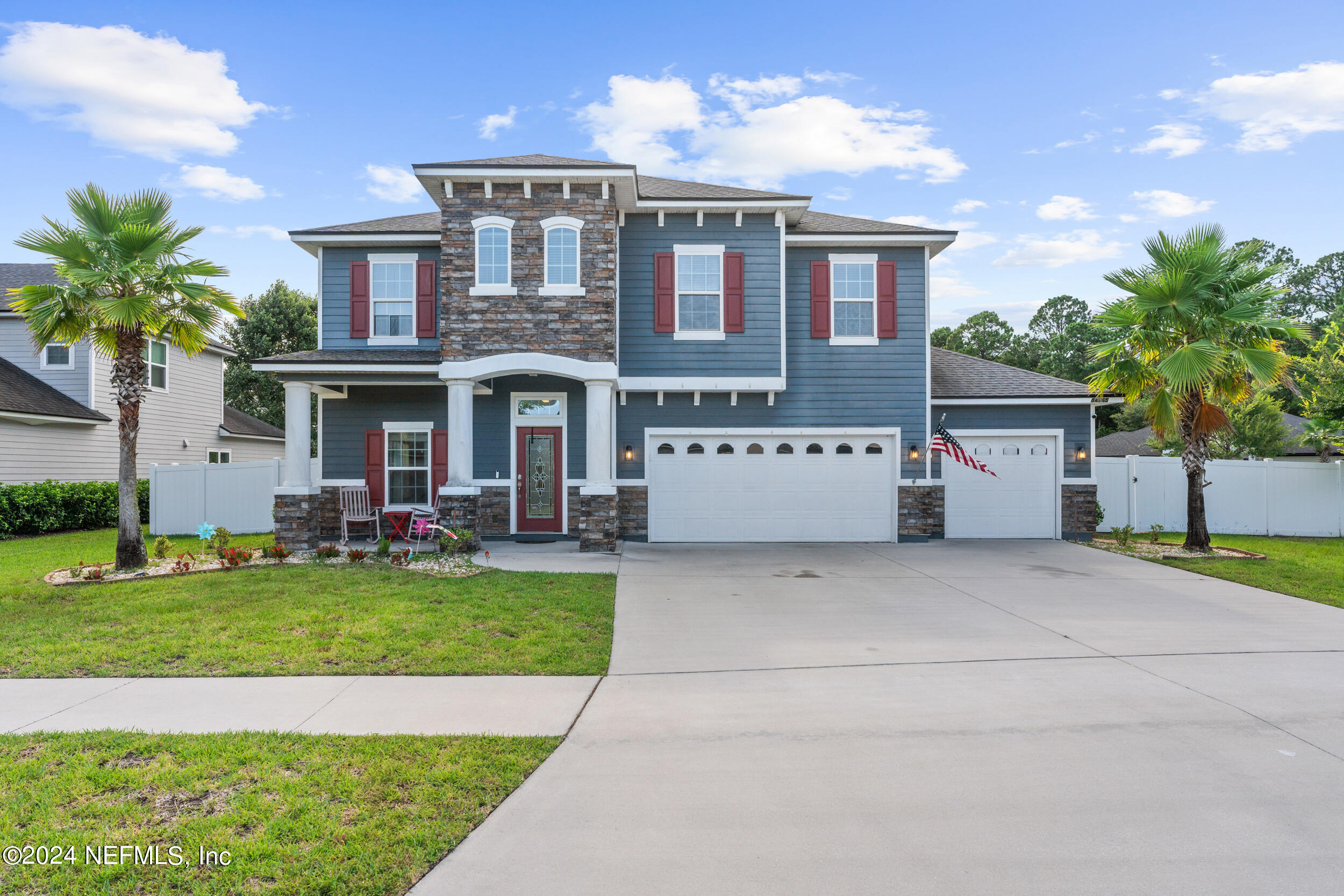 a front view of a house with a yard garage and outdoor seating