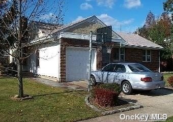 a front view of a house with cars parked