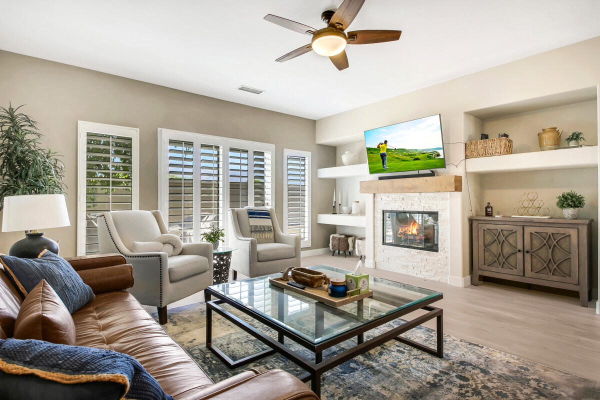 a living room with furniture a fireplace and a flat screen tv