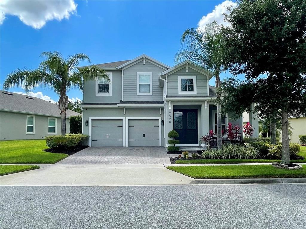 a front view of a house with a yard and garage