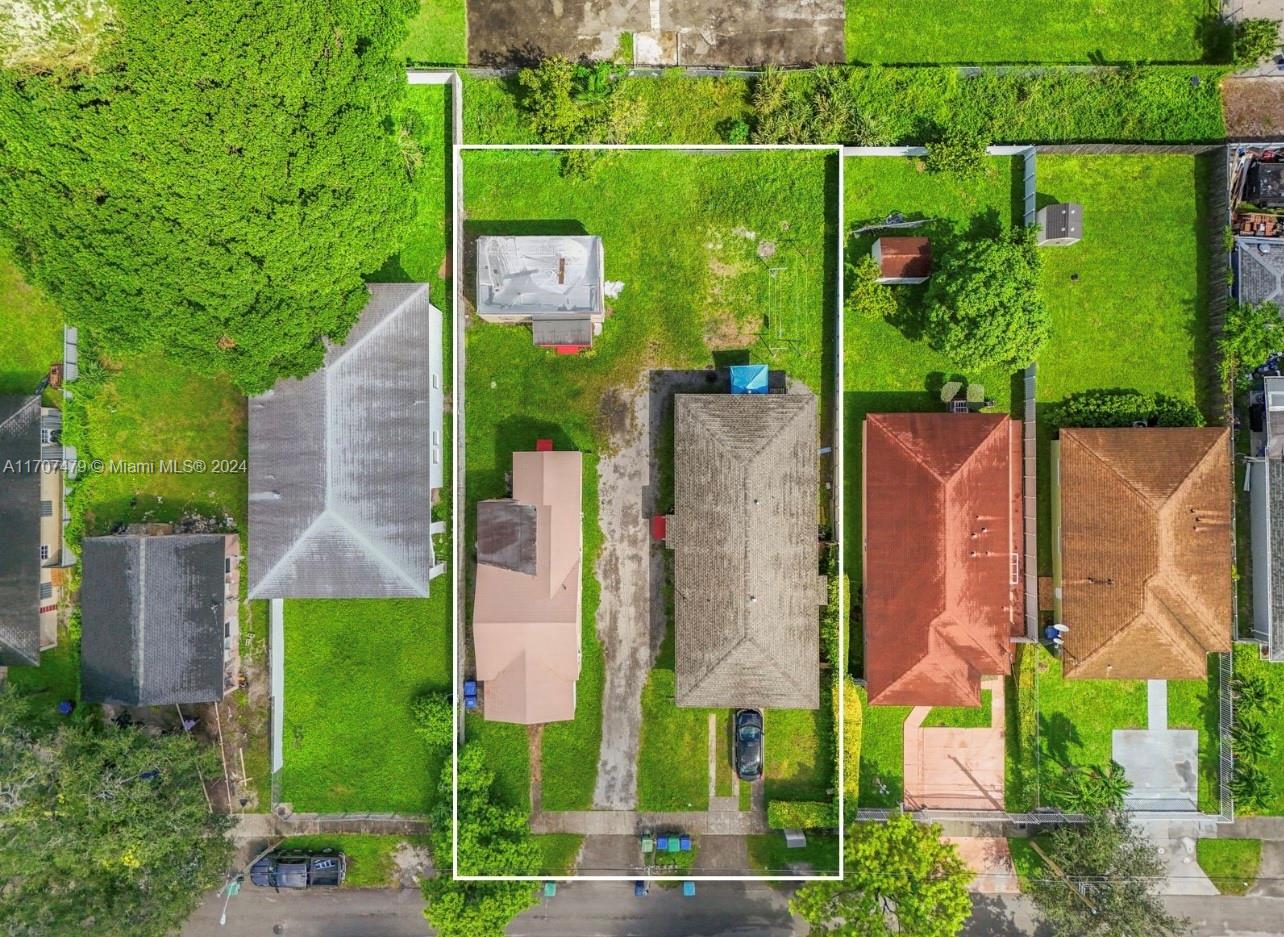 an aerial view of a house with a garden and trees