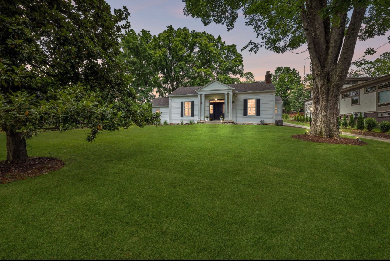 a front view of a house with a garden