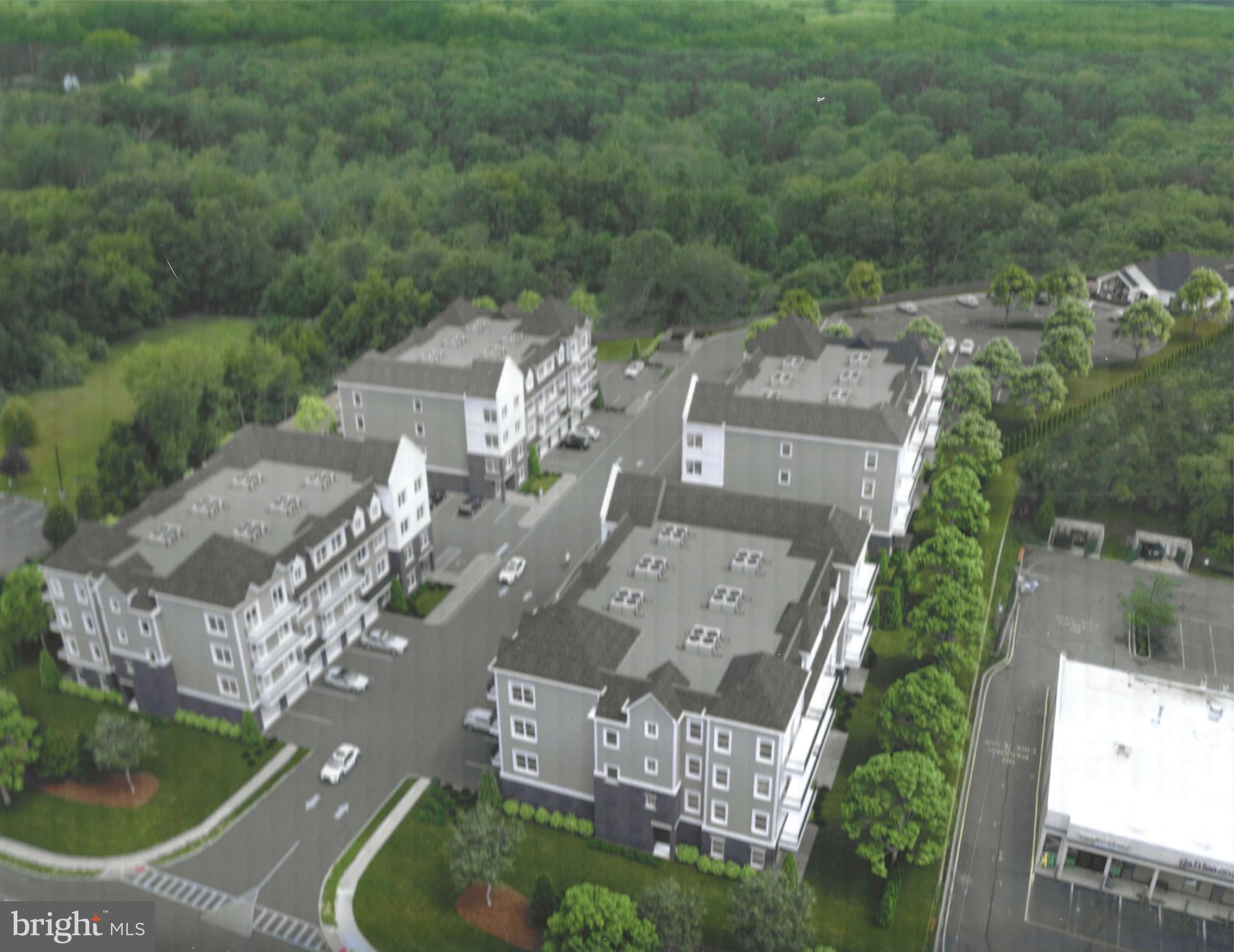 an aerial view of residential houses with outdoor space and trees