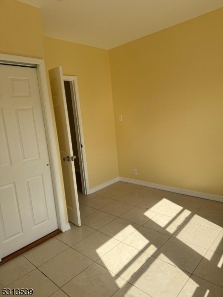 a view of a room with wooden floor and white walls