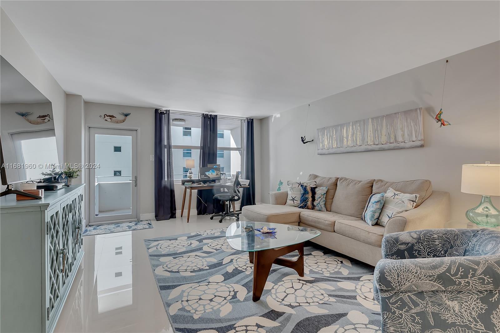 a living room with furniture a rug and a table