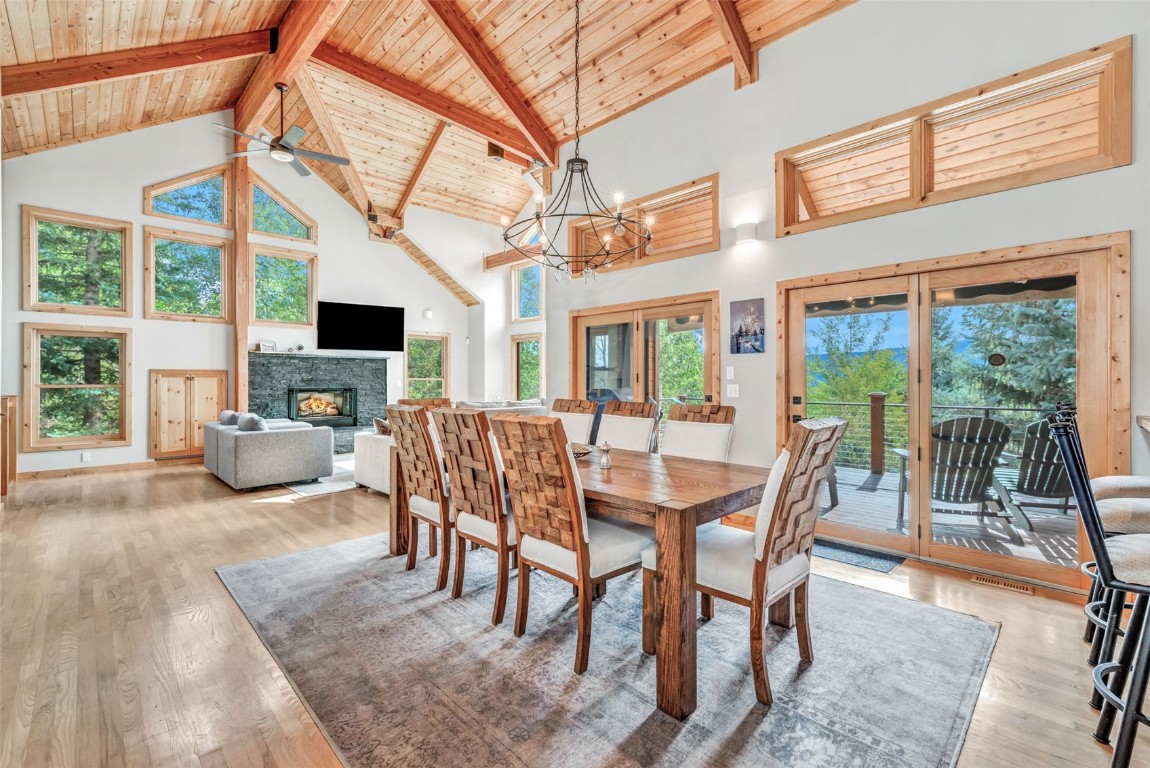 a view of a dining room with furniture water view and a fireplace