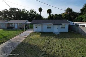 a view of a house with a backyard