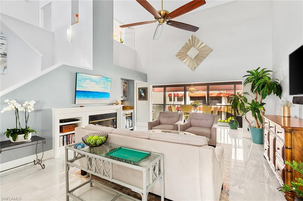 a living room with fireplace furniture and a potted plant