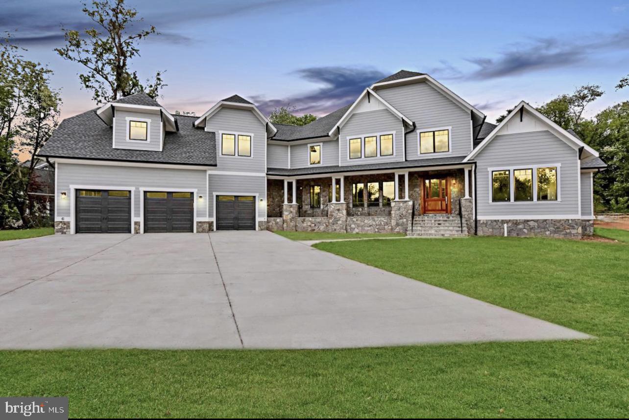 a front view of residential houses with yard and green space