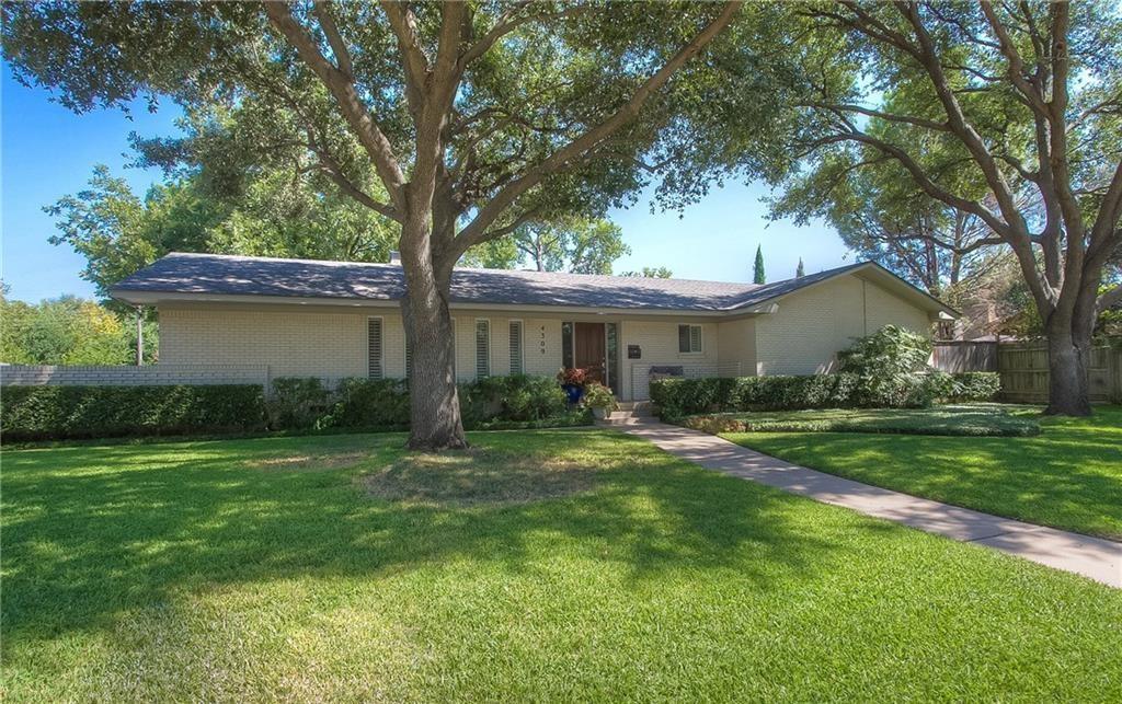 a front view of a house with a yard and porch