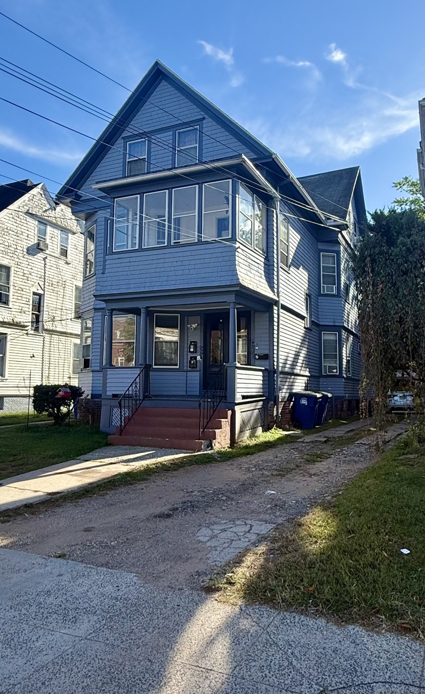 a view of a big house with a yard and plants