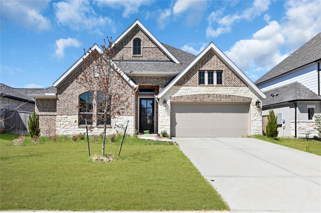 a front view of a house with a yard and entertaining space