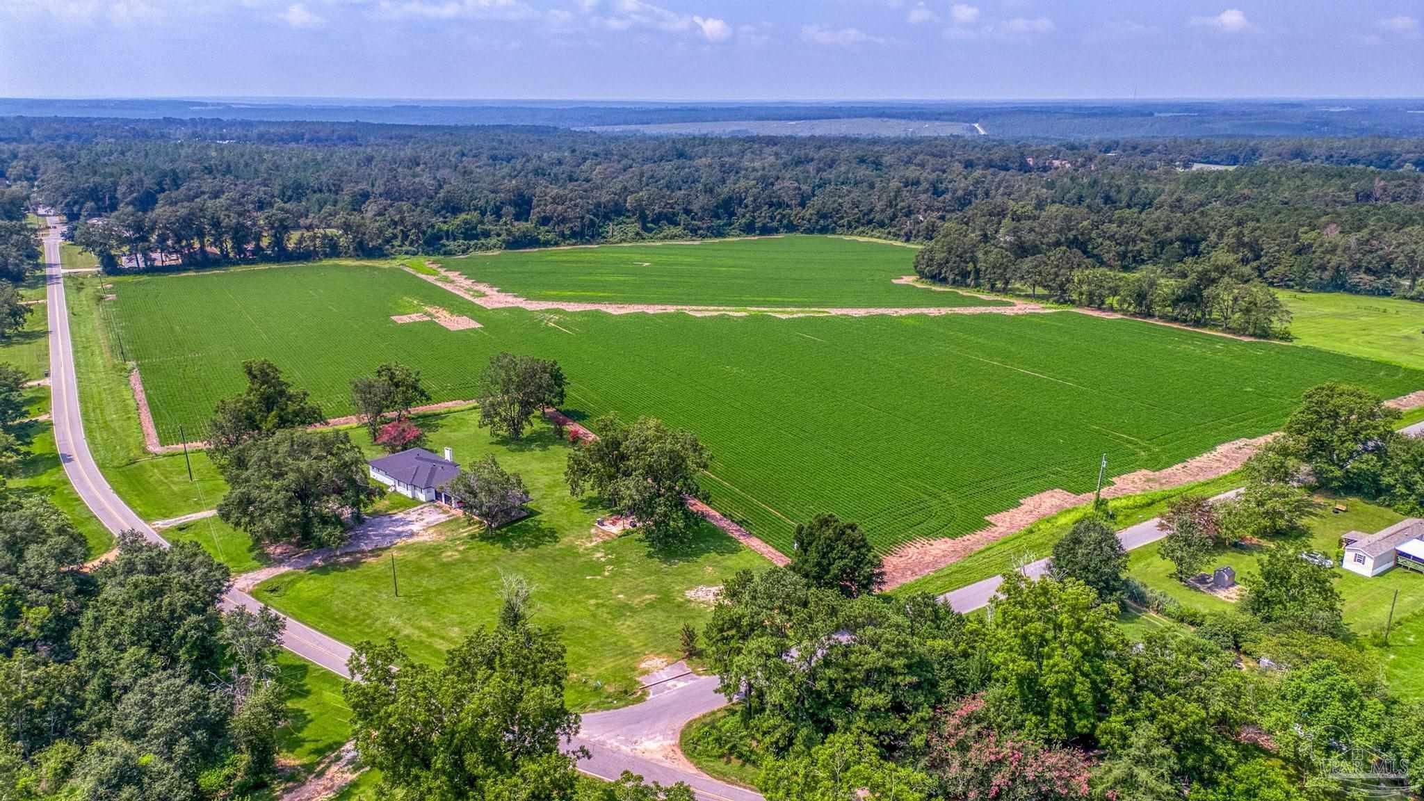 an aerial view of a houses with a yard