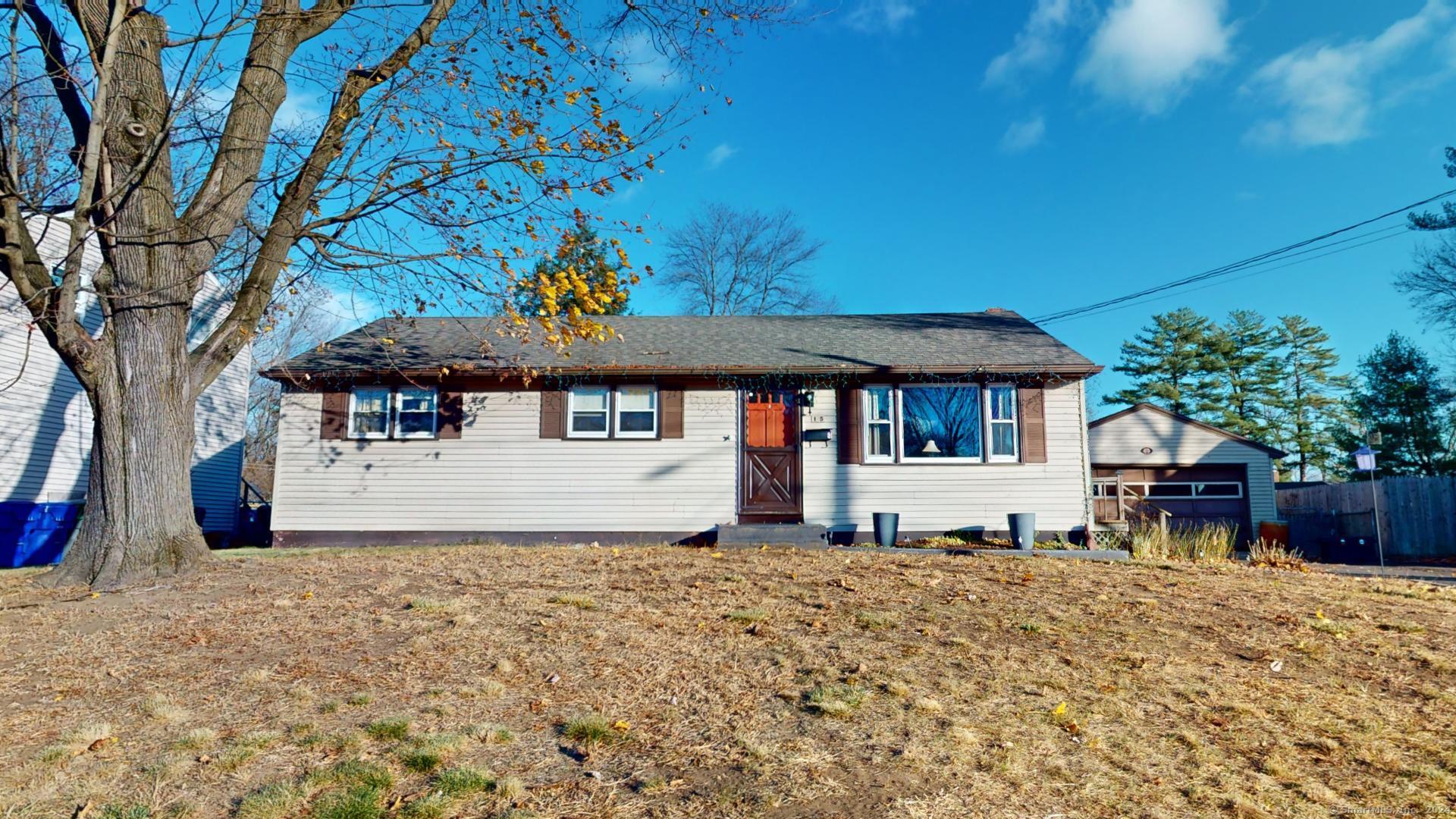 a view of house with a yard