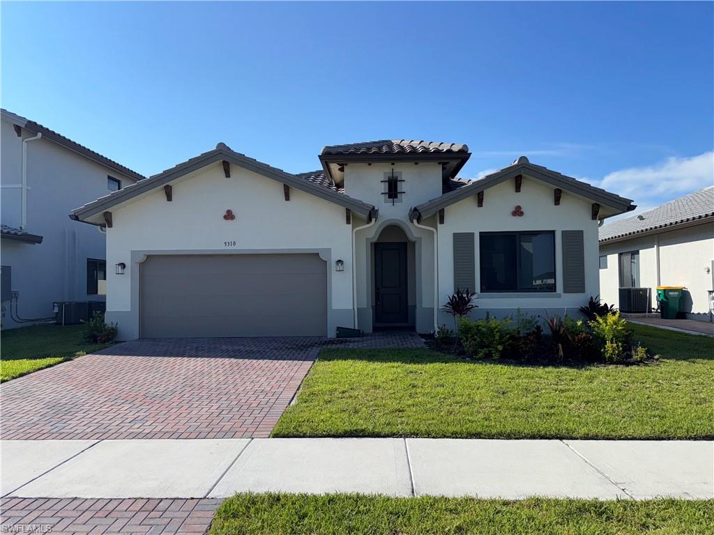 Mediterranean / spanish home with paved driveway.