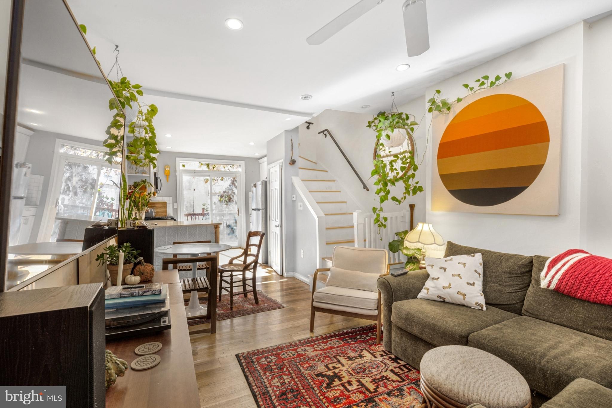 a living room with furniture a rug and a chandelier