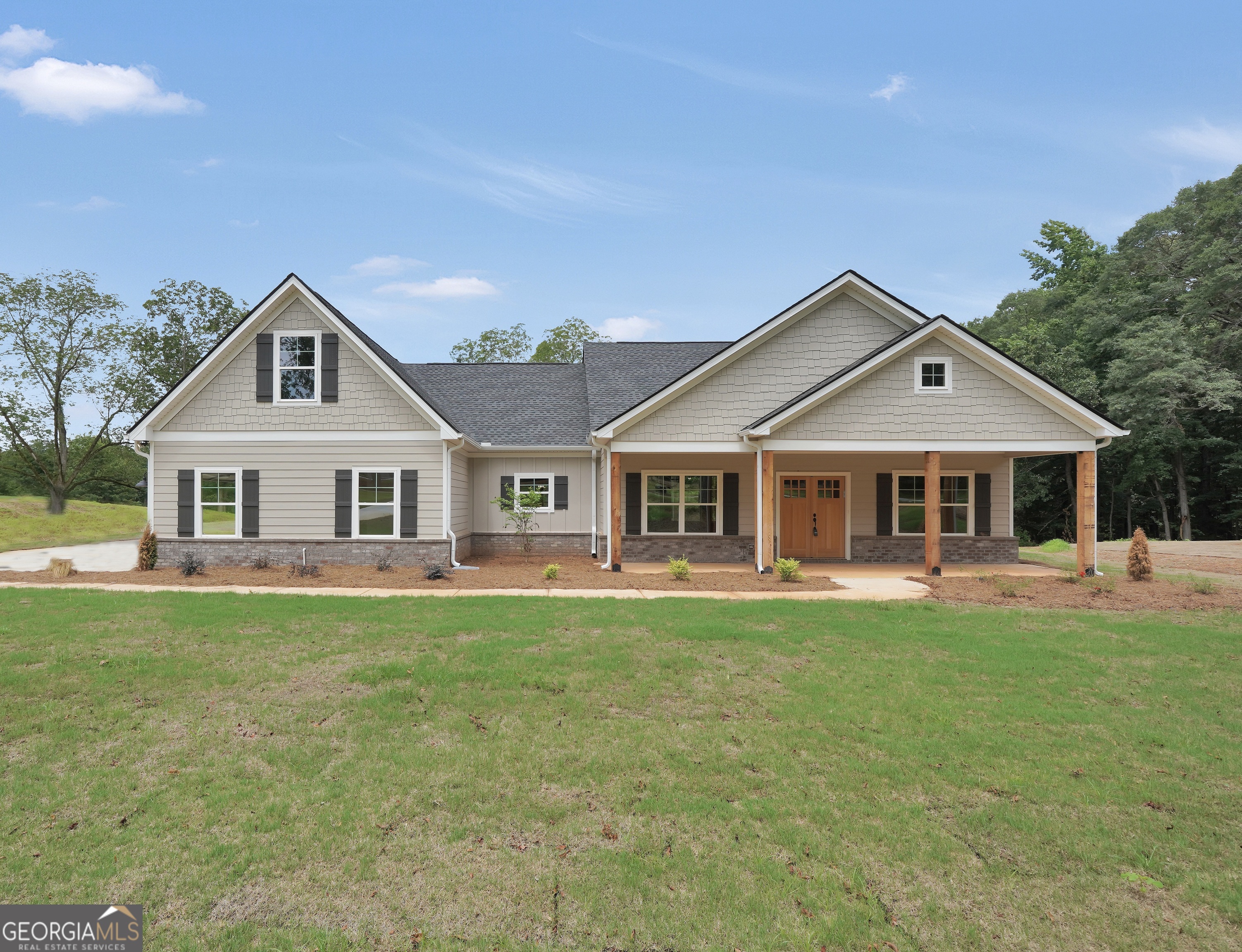 a front view of a house with a garden