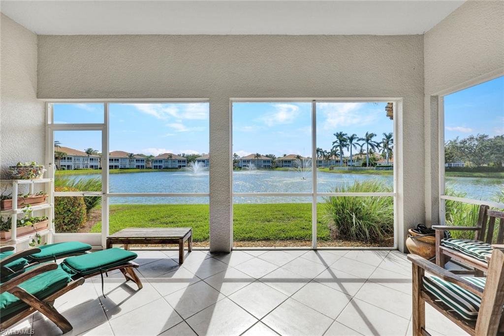 Sunroom / solarium featuring a water view