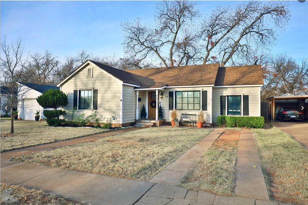 a front view of a house with a yard and porch