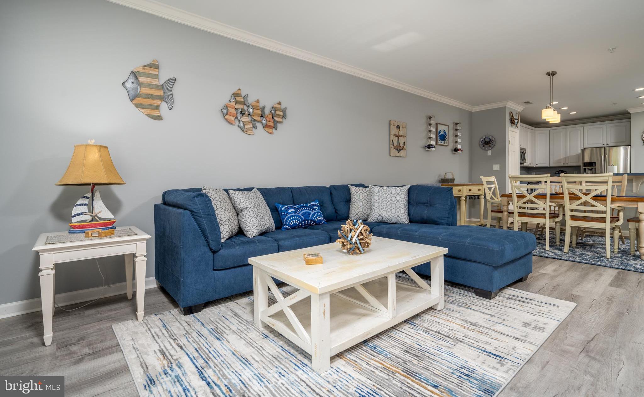 a living room with furniture and a dining table with rug